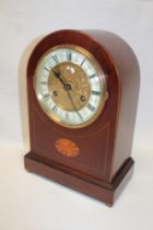 A late Victorian/Edwardian mantel clock with brass mounted decorated circular dial in inlaid