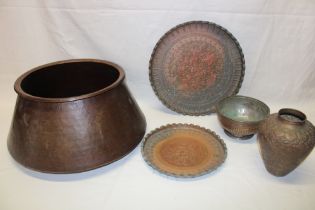 A Middle Eastern copper circular tapered pot, 17" diameter, Middle Eastern copper trays, vase etc.