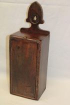An early 19th century elm wall mounted rectangular candle box with sliding front cover,