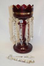 A Victorian ruby tinted glass table lustre with painted decoration and glass lozenge droplets,