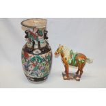 An Eastern pottery figure of a Tang-style horse and a Japanese Satsuma pottery tapered vase with