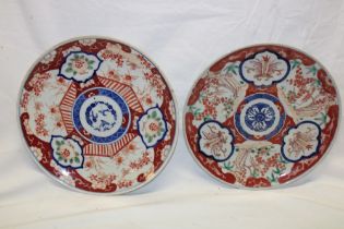 Two similar Japanese Imari pottery circular chargers with painted figure and floral decoration,