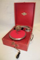 A small portable gramophone by Orphee in red fibre case