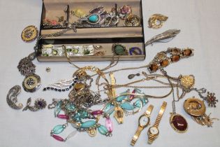 A jewellery box containing a quantity of various costume jewellery including ladies' wristwatches,