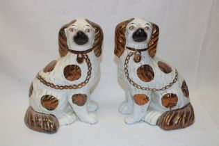 A pair of Victorian Staffordshire pottery seated spaniel figures with copper lustre decoration,