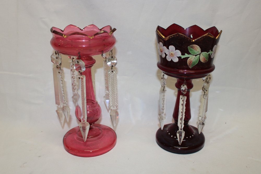A cranberry tinted glass table lustre with lozenge droplet decoration,