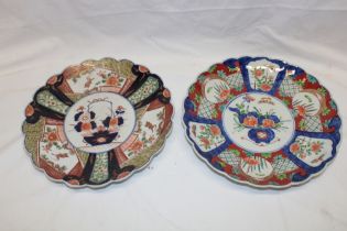 Two 19th century Japanese Imari pottery circular chargers with blue and red floral decoration,