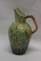 A Royal Doulton Slater's patent pottery tapered jug with floral decoration on green and orange