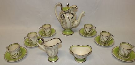 A Susie Cooper china coffee set with silver and green decoration comprising a tapered pedestal