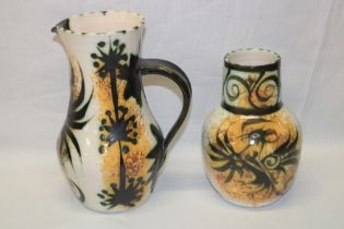 A Cornish Celtic pottery tapered jug with painted decoration,