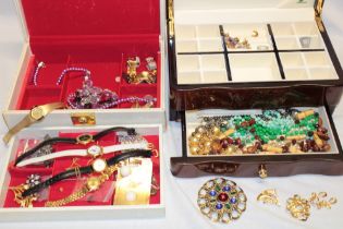 Two jewellery boxes containing costume jewellery, cuff links,