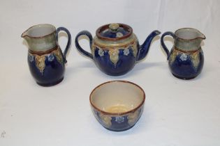 A Royal Doulton pottery four-piece tea set with green and blue glazed decoration comprising a
