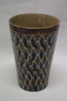 A Doulton Lambeth pottery tapered beaker with blue and brown decoration