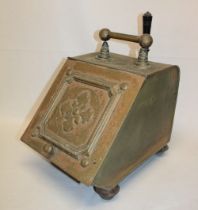 An Edwardian brass coal-box with hinged sloping front and attached shovel