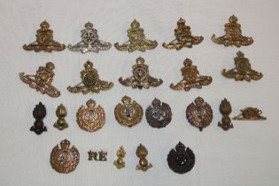 A selection of various military Corps cap badges including REME, Royal Army Catering Corps,