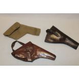 Two First War leather revolver holsters and a Second War webbing holster dated 1943 (3)
