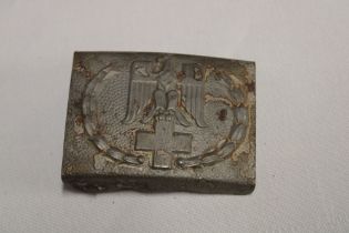 An original Second War German Red Cross alloy belt buckle with raised eagle decoration