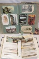 Two albums containing a large selection of mixed black and white and coloured postcards -