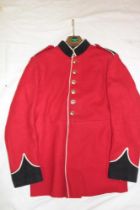 A scarlet military tunic with blue facings and anodized buttons