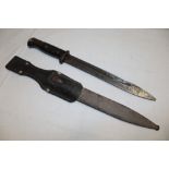 A Second War German Mauser bayonet with single edged blade in steel scabbard with leather frog (af)
