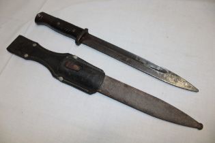 A Second War German Mauser bayonet with single edged blade in steel scabbard with leather frog (af)