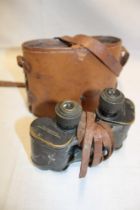 A pair of 6x30 military stereo binoculars by the Crown Optical Company USA in leather carrying case