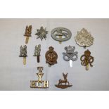 Various military cap badges including Northamptonshire Yeomanry, brass shoulder title "T/Y/R.G.H".