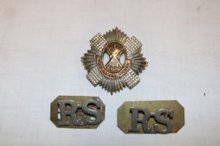 A Royal Scots cap badge and pair of shoulder titles