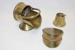 Three pieces of trench art including brass shell case peaked cap dated 1917,