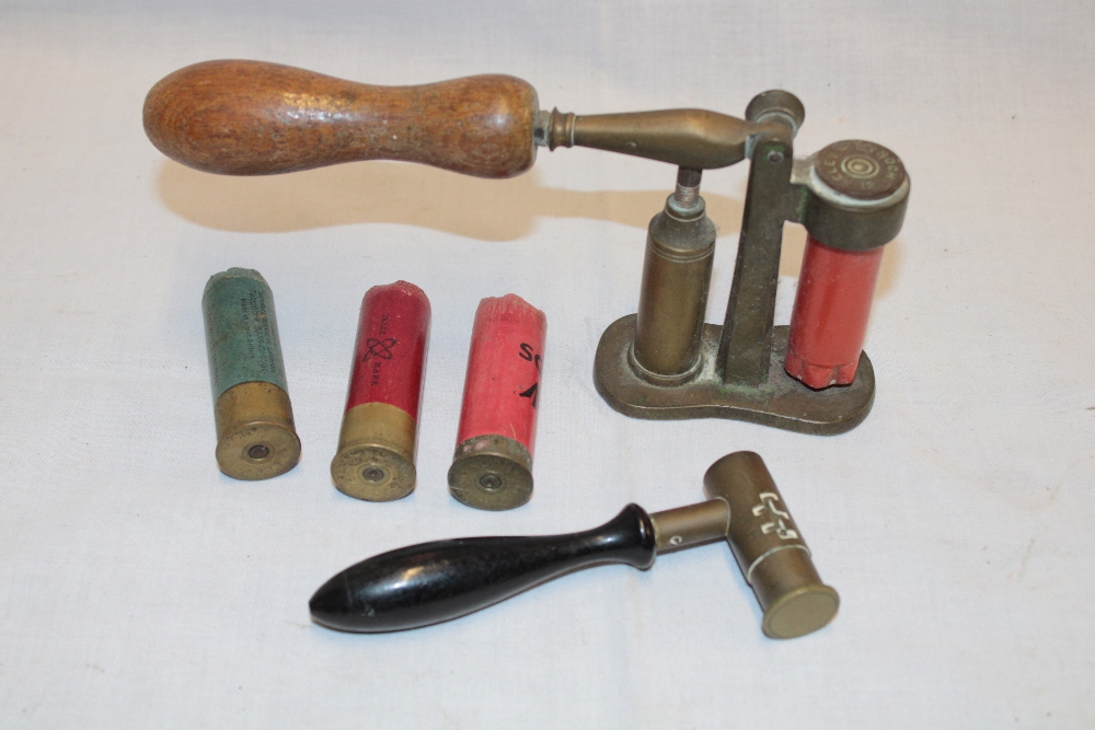 A brass mounted 12 bore cartridge recapping tool and an old brass ...
