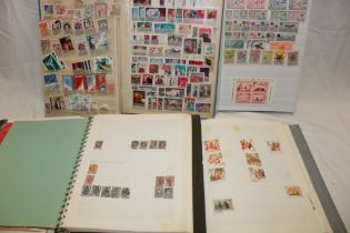 Two albums and two stock books containing a selection of Russian stamps together with Serbia,