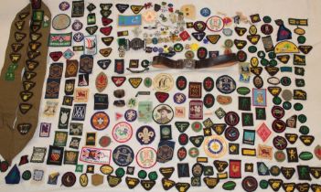 A large selection of various Boy Scout and Girl Guide badges including proficiency badges,