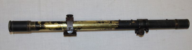 An early blackened brass telescopic sight marked "2¾ - x" with Winchester steel mounts,