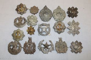 Seventeen various Scottish military cap badges including the Royal Scots, Highland Light Infantry,