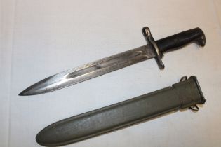A Second War American M1 Garand bayonet with 9½" Bowie-point blade in composition scabbard