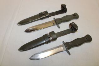 Two West German combat knives with single edged blades in steel scabbards