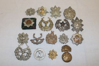 Eighteen various Scottish military cap badges including Lovat's Scouts, Royal Scots,