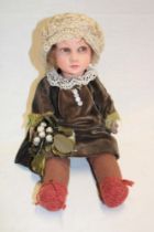 An old French doll marked "Fabrique en France" with cloth body,