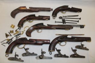 A selection of various pistol parts, mainly modern, including locks, stocks,