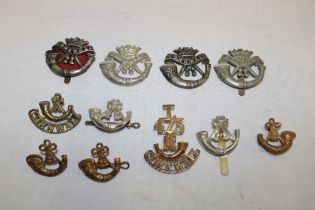 Various Cornish military badges including "T/4-5/Bugle/Cornwall" shoulder title, DCLI cap badges,