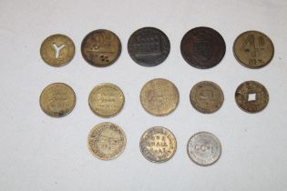 A selection of various brass trade tokens including Williams Brothers, Hartlepool Co-op,