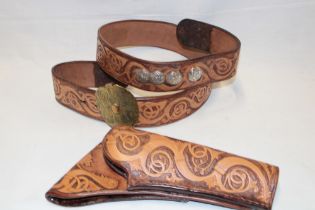 A good quality tooled leather Western-style holster with matching belt and brass buckle