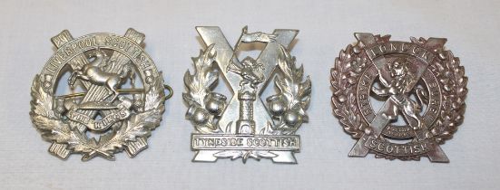 Three Scottish military cap badges including Tyneside Scottish,