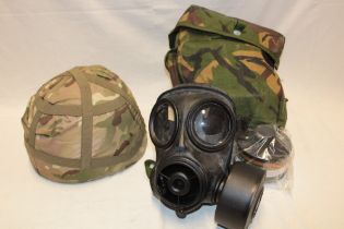 A British MK6 combat helmet with camouflage cover together with an S10 respirator,