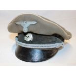 A Second War German SS Officer's peaked cap in relic condition, grey cloth with white piping,