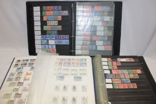 Three albums/stock books containing a collection of GB stamps,