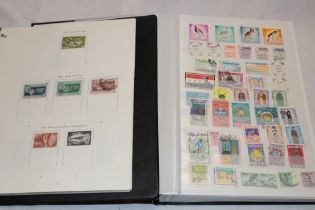 A folder album containing a selection of Middle East stamps and an album of Israel stamps (2)