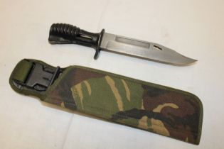 A British SA80 bayonet in camouflaged combat cover/scabbard dated 1994