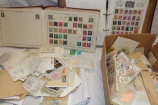 Two albums containing various World stamps and numerous World stamps in envelopes and packets
