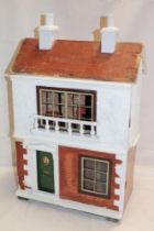 A 1920's/30's doll's house by Lines Brothers with hinged opening front and a small selection of
